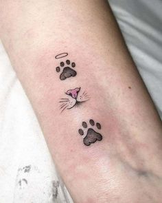 a cat paw tattoo on the left arm