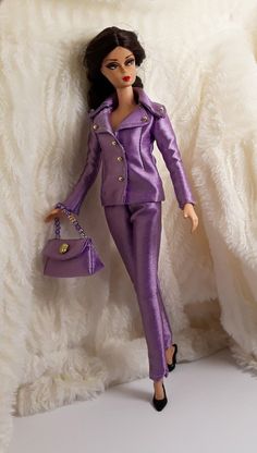 a barbie doll dressed in purple holding a purse