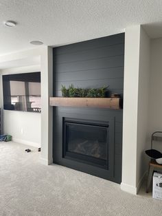 an empty living room with a fireplace in it