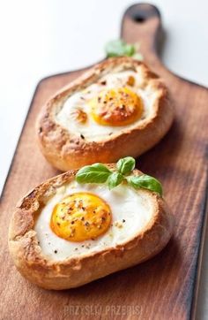 two eggs in bread on a cutting board