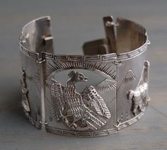 A large vintage 1940's sterling silver Peruvian link cuff bracelet, with Inca and llama relief design, presented by MintAndMade. This wide, intricate cuff bracelet consists of five links depicting Peruvian themes, such as llamas, mountains, Incan bird and two figures in traditional garb. It has a lovely vintage patina, but let me know if you would like me to polish it. It is in good vintage condition, however, the clasp is slightly bent. It still opens and closes just fine. Please feel free to c Relief Design, Silver Turquoise Jewelry, Muslin Bags, Bracelet Vintage, Sea Glass Jewelry, Ethnic Jewelry, Vintage Bracelets, Vintage Shop, Artistic Jewelry