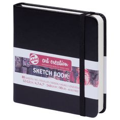 a black and white notebook with the words sketch book on it's front cover