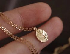 Dainty and elegant small oval necklace, nature-inspired leaf pendant necklace made in solid gold * Pendant material: 10K Yellow Gold * Pendant size: 9.5x7mm * Necklace material: 14K Yellow Gold * Necklace length: 16.5" * Stamp: 10K ❤️Visit our official website for exclusive new products.      https://elekalonjewelry.com/ ❤️Follow us on Instagram @ elekalonjewelry for the latest projects and much more! ❤️If you have any questions, please feel free to message us. Nature-inspired Gold Necklace With Oval Pendant, Plant Necklace, Necklace Minimalist Jewelry, Necklace Leaf, Gold Leaf Necklace, Delicate Pendant, Jewelry Delicate, 14k Yellow Gold Necklace, Oval Necklace