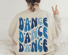 "Elevate your dance passion with our \"Dance\" sweatshirt, the perfect addition to your dance apparel collection. Whether you're a dedicated dance mom, a passionate dancer, or a beloved dance teacher, this sweatshirt is a versatile and stylish gift for everyone in the dance community. Show your support and love for dance while staying cozy and fashionable. Don't miss the opportunity to showcase your dedication with this thoughtful gift, making every dance competition and practice session even more memorable. Get your \"Dance\" sweatshirt today and let your passion for dance shine! 💃🩰 Ideal for any situation, a unisex heavy blend crewneck sweatshirt is pure comfort. These garments are made from polyester and cotton. This combination helps designs come out looking fresh and beautiful. The Dance Competition Gifts, Dance Shirts Ideas, Dance Mom Shirt, Dance Sweatshirt, Dance Mom Shirts, Dance Apparel, Dance Rooms, Community Show, Dance Gifts