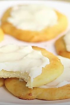 several pastries with icing on a white plate