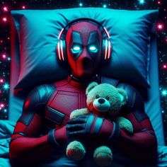 a teddy bear sitting in front of a bed with a deadpool character on it