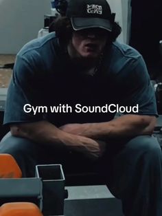 a man sitting down with his arms crossed in front of him and the words gym with soundcloud