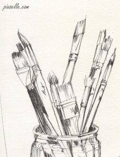 pencils and paintbrushes in a glass jar