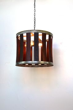 a light fixture hanging from a chain in a room with white walls and flooring