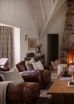 a living room filled with furniture and a fire place