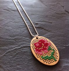 a wooden necklace with a flower on it