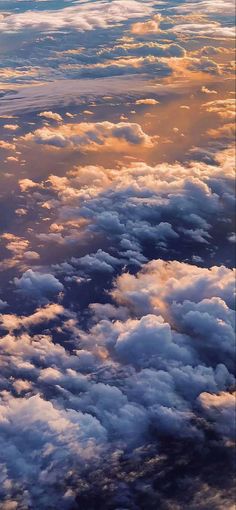 the sky is filled with clouds as seen from an airplane