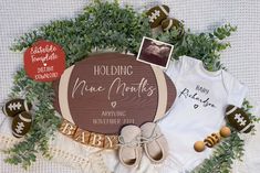 a baby announcement with clothes, shoes and other personalized items on top of it