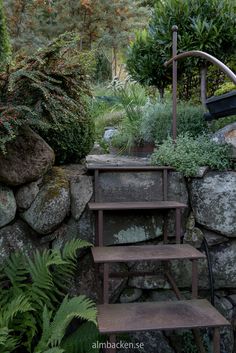 a set of steps leading up to a rock wall