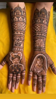 two hands with henna designs on them