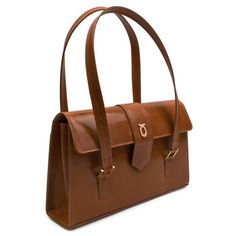 Aida Handbag in Tan/Brown This grand and capacious bag is one of Launer's newer designs. Practical, beautiful, and wonderfully Launer, this piece is an emerging favorite. Suitable for both professional engagements and daywear, this piece is a wonderful, versatile investment. Each of these soft leather handbags is made-to-order, following the exacting standards of the client. The leather is imported from Italy and only butter-soft, unblemished hides are chosen by their leather buyer. Every piece Timeless Shoulder Bag With Top Handle And Leather Lining, Timeless Top Handle Shoulder Bag With Leather Lining, Classic Handheld Business Shoulder Bag, Timeless Formal Flap Shoulder Bag, Timeless Formal Shoulder Bag, Elegant Satchel Shoulder Bag For Travel, Elegant Top Handle Shoulder Bag For Everyday, Timeless Formal Shoulder Bag With Double Handle, Elegant Rectangular Satchel With Leather Handles