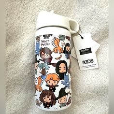 thermos cup is decorated with cartoon characters and has a tag attached to it