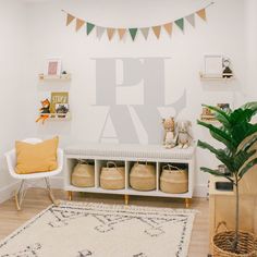 a white bench sitting next to a plant in a living room filled with furniture and decor