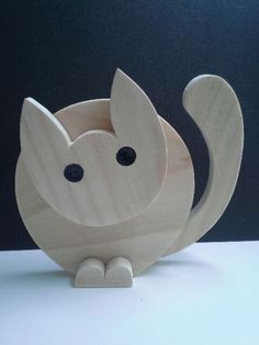 a wooden cat figurine sitting on top of a table