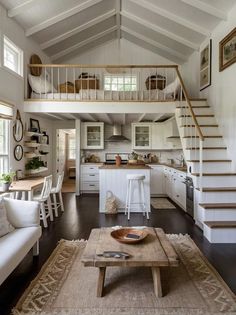 a living room filled with furniture and a staircase