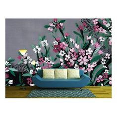 a living room with flowers painted on the wall and a couch in front of it