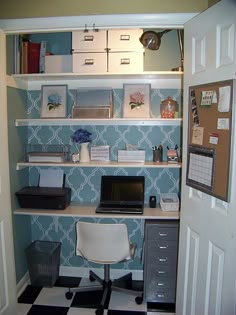 a desk with a laptop computer on top of it next to a checkered floor