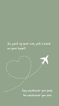 an airplane is flying through the sky with a heart on it's tail and some words written below