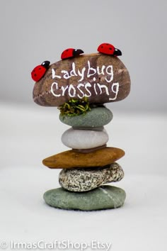 a stack of rocks with ladybug crossing written on it