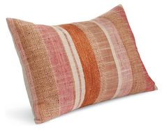 an orange and pink striped pillow on a white background