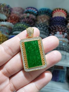 Statement piece Jade and Gold Vermeil pendant bezeled with Zircon crystals; ideal jewellery gift🎁 for Mom and Dad alike. Beautiful, bespeckled green Jade rectangular cabochon (1.5 cm x 2.8 cm); Fei Cui, Type A natural Jadeite Jade (non-bleached, non-dyed, non-treated material). Elegantly designed, heirloom-material Filigree pendant with a biting Jaguar bail (hole 2.5 mm). Hallmarked S925; pendant height 4.8 cm, width 2.5 cm and weighs 10.15 grams. Luxury Green Cabochon Jewelry, Luxury Emerald Rectangular Pendant Jewelry, Gift Jewelry With Handset Crystal Stones, Crystal Square Pendant Jewelry Gift, Crystal Square Pendant Jewelry For Gifts, Crystal Jewelry Square Pendant For Gifts, Luxury Crystal Jewelry Rectangular Shape, Luxury Green Square Pendant Necklace, Silver Emerald Rectangular Pendant Jewelry