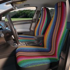 the interior of a car with multi colored seat covers