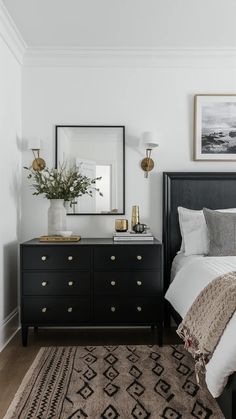 a black and white bedroom with gold accents