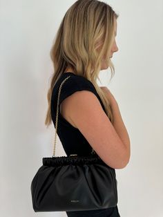 Elevate your style with the DeMellier Miami Clutch in Black. From day to night, this modern and elegant bag effortlessly transitions with you. The delicate gold chain handle adds a feminine touch and makes it a breeze to carry anywhere. Plus, the sustainably sourced cowhide leather provides a luxurious and sustainable shine. Make a statement while being environmentally conscious with this chic bag! Material: Cowhide leather, luxurious black lining made with 30% recycled cotton and 70% cotton Det Timeless Evening Bag For Everyday Use, Chic Evening Shoulder Bag With Gold-tone Hardware, Chain Clutch Evening Bag For Night Out, Modern Black Shoulder Bag With Chain, Chic Clutch With Gold-tone Hardware, Modern Shoulder Bag With Chain Strap For Night Out, Evening Shoulder Bag With Chain Pouch, Chic Evening Clutch With Gold-tone Hardware, Elegant Evening Bag With Chain Strap For Night Out