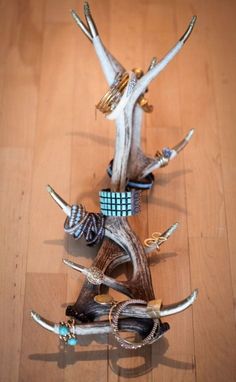 a group of rings and bracelets on top of a wooden table