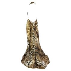 Introducing a striking leopard print gown from the Yves Saint Laurent Rive Gauche collection, designed by Tom Ford for the Spring/Summer 2002 season. This gown features a plunging cowl neckline, an open back, and an impressive train. The abundance of fabric is expertly tailored to sculpt a sleek and seductive silhouette, showcasing Ford's meticulous attention to detail. This collection is remembered for its laid-back yet glamorous aesthetic, epitomizing unassuming elegance. The distinctive leopa Elegant Leopard Print Maxi Dress For Evening, Ysl Dress, Glamorous Aesthetic, Printed Gowns, Silk Gown, Rive Gauche, Cowl Neckline, Primavera Estate, Evening Gown