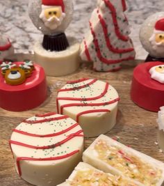 several different types of soaps sitting on a table with snowmen and santa clause decorations