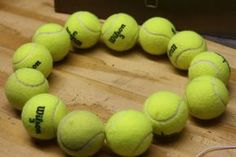 a bracelet made out of tennis balls on a table