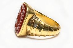 Antique Yellow Gold Carnelian Crest Men's Ring. This impressive Antique Yellow Gold Carnelian Crest Men's Ring boasts a timeless design and showcases a stunning carnelian crest. Crafted in rich 18K yellow gold, it exudes elegance and sophistication. Enhance your style and make a statement with this unique piece. Ring weighs 18.7 grams. Ring Size 10. Formal Carnelian Signet Ring With Polished Finish, Classic Carnelian Signet Ring For Formal Events, Classic Carnelian Signet Ring For Formal Occasions, Formal Red Carnelian Signet Ring, Luxury Carnelian Ring For Formal Occasions, Formal Carnelian Gold Ring, Formal Gold Carnelian Ring, Gold Carnelian Signet Ring With Polished Finish, Elegant Gold Signet Ring With Carnelian