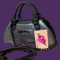 Betsey Johnson Adjustable Crossbody Strap & Rolled Carry Handles Silver Glitter/Sparkle On Vegan Leather Zip Closure, With A Detachable Strap The Lining Is Made Of Multicolor Fabric This Purse Is Part Of The Luv Betsey Line Great For Spooky Season Or All Year Round! Nwt Measurements: Approx. 10” X 4.5” X 3” Handle Drop 4” Adjustable Strap Approx 21” Betsey Johnson Purses, Betsey Johnson Bags, Silver Glitter, Betsey Johnson, Purses Crossbody, Adjustable Straps, Black Silver, Vegan Leather, Bat