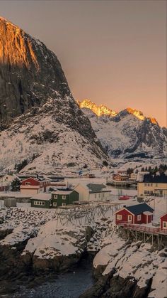 the mountains are covered in snow and houses