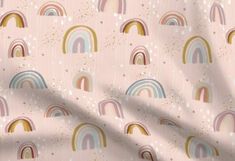 a pastel pink wallpaper with rainbows and stars in the sky on it