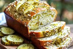 sliced loaf of bread with pickles and sesame seeds