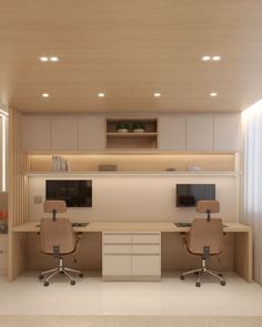 an office with two desks and chairs in the middle of it, all lit up by recessed lights