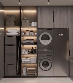 a washer and dryer in a room with wooden shelves on the wall next to each other