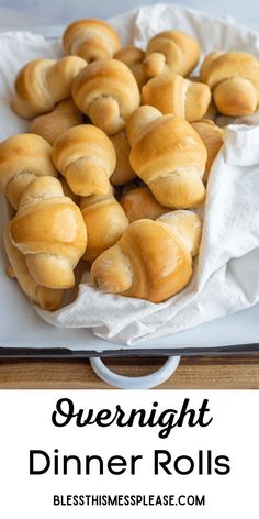 a white plate topped with bread rolls on top of a wooden table and text overlay reads overnight dinner rolls