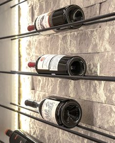 several bottles of wine are lined up on the wall