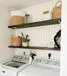 a washer and dryer in a small room with shelves above the washer