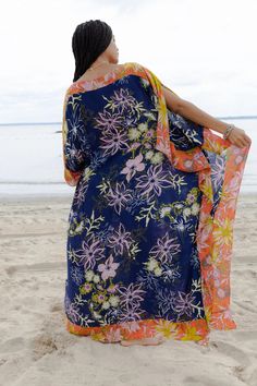 Our lovely Wildflower Kaftan showcases a range of floral motifs and delicate botanical elements in varying sizes and styles. The cinched sides of the garment create a unique drape that flatters all body types, enhancing natural beauty and complementing individual styles. The design also allows for easy movement, ensuring maximum comfort throughout the day. This kaftan, made from lightweight material, is the perfect choice for a luxurious and stylish outfit, whether you're lounging by the pool or spending a summer day in town. Material: 100% Rayon Color: Navy Combo Beach Tropical Print Dress, Multicolor Summer Floral Dress With Vibrant Print, Multicolor Floral Dress With Vibrant Print For Summer, Multicolor Floral Sundress For Vacation, Vibrant Multicolor Floral Print Maxi Dress, Tropical Orange Floral Print Maxi Dress, Multicolor Tropical Print Floral Dress For Vacation, Multicolor Tropical Print Summer Floral Dress, Multicolor Floral Print Dress For Vacation