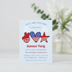 an american flag themed party card with two thumbs up and stars in the middle, sitting on a table next to a plant