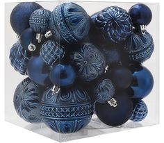 a bunch of blue ornaments in a clear box